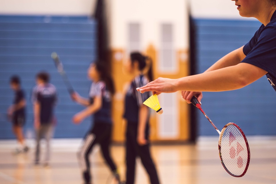 man serving to start the badminton game