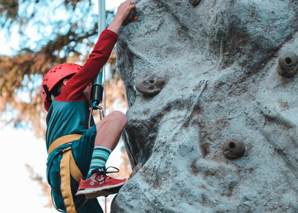 man rock climbing to master techniques